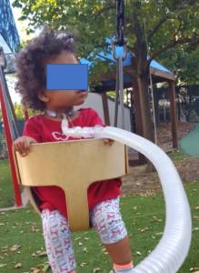 On swing Fig. 4. This photo was taken approximately one year after the child returned home.